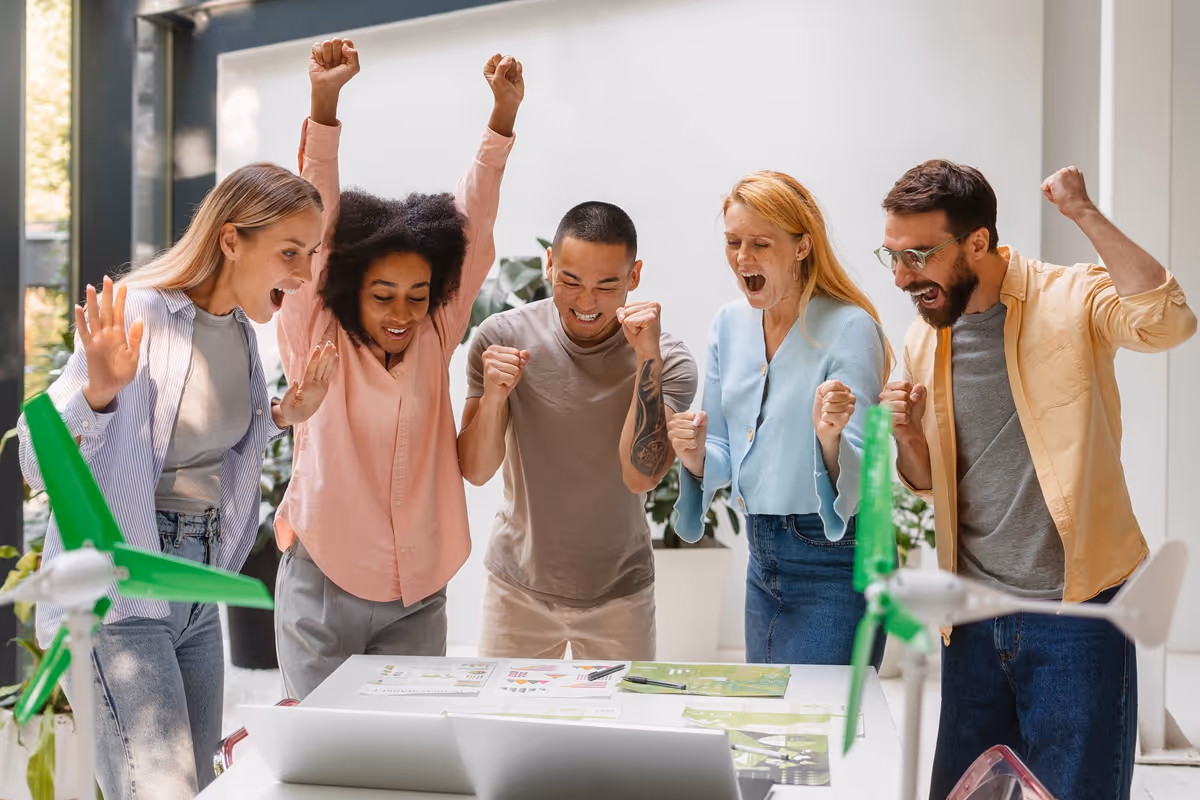 Employees celebrating around a table