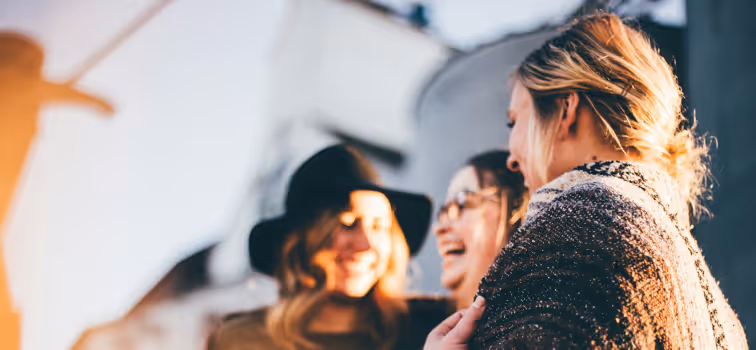 Three Irish ladies laughing outside