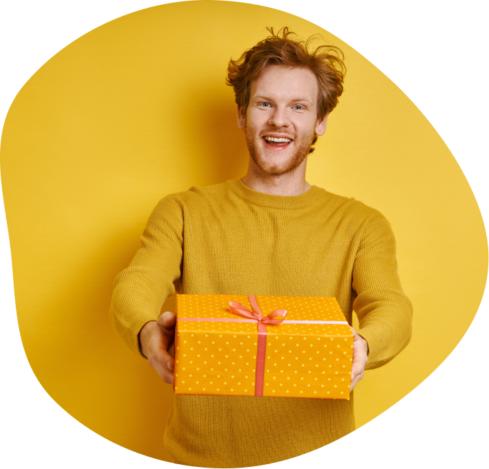 Man in yellow jumper holding a yellow gift box